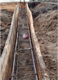 Steel reinforcement bars tied and set into a foundation trench