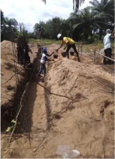 Workers digging foundation trenches by hand at the New Cess school site